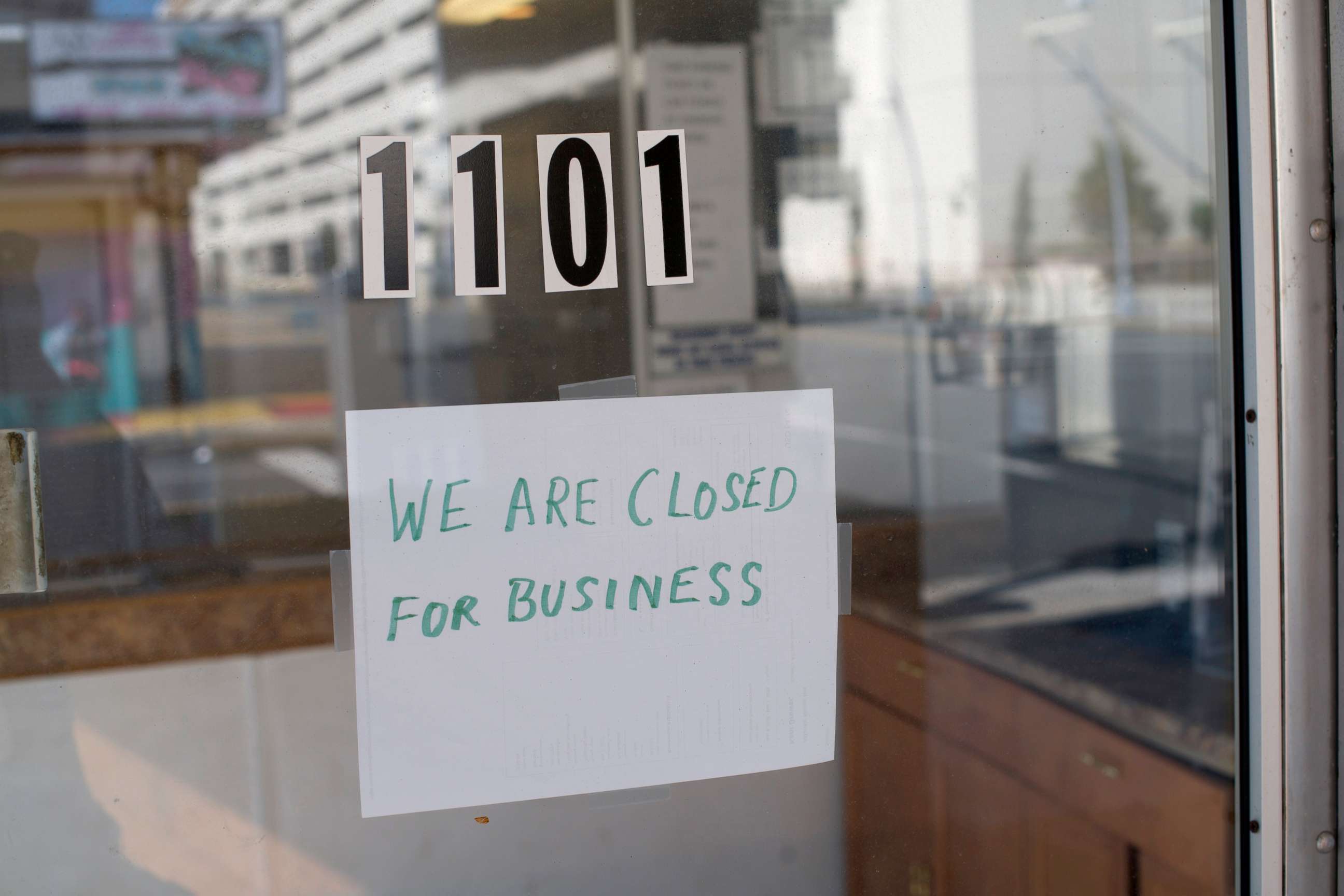 PHOTO: A sign at a motel lobby states "WE ARE CLOSED FOR BUSINESS" during the coronavirus pandemic on May 7, 2020 in Atlantic City, New Jersey.