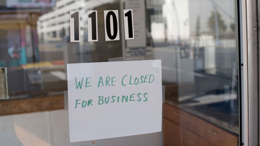PHOTO: A sign at a motel lobby states "WE ARE CLOSED FOR BUSINESS" during the coronavirus pandemic on May 7, 2020 in Atlantic City, New Jersey.
