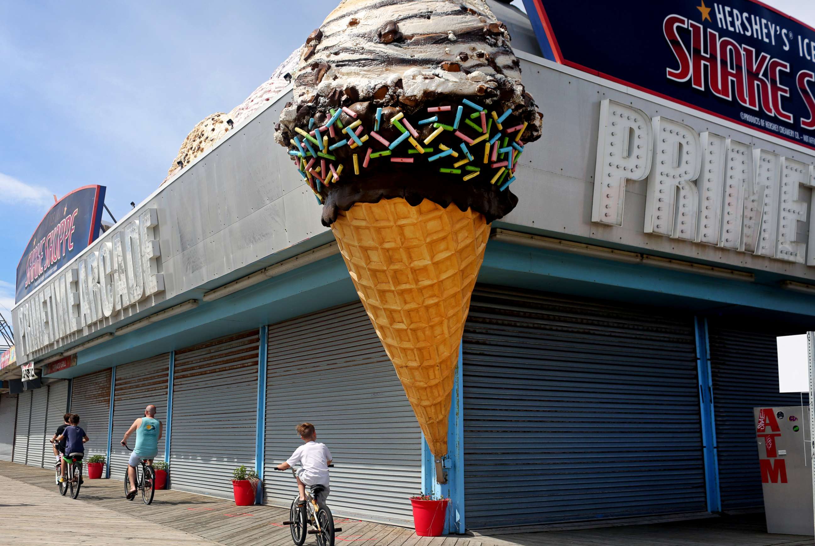 PHOTO: People traverse the Seaside Heights boardwalk as the state begins to reopen beaches and boardwalks amid the novel coronavirus pandemic on May 16, 2020 in Seaside Heights, New Jersey.