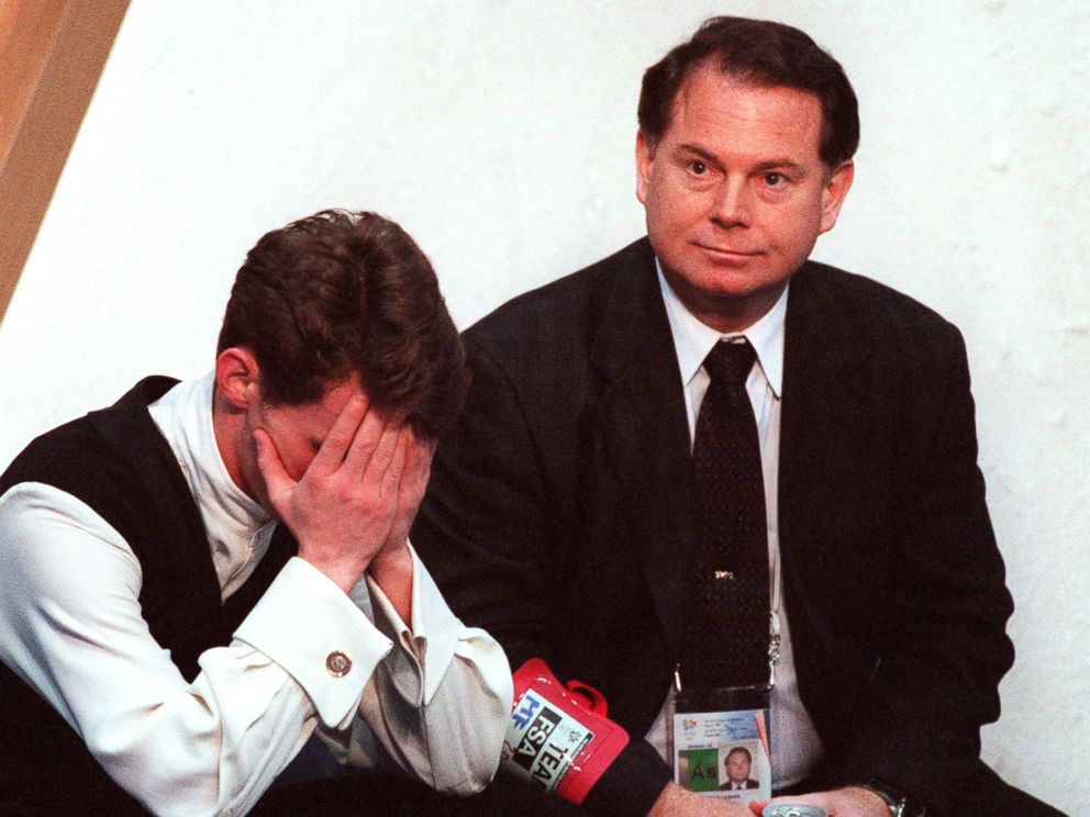 PHOTO: With coach Richard Callaghan at his side, American figure skater Todd Eldredge hangs his head as he waits for his scores following the finals of the mens figure skating competition at the 1998 Winter Olympics in Nagano, Japan.