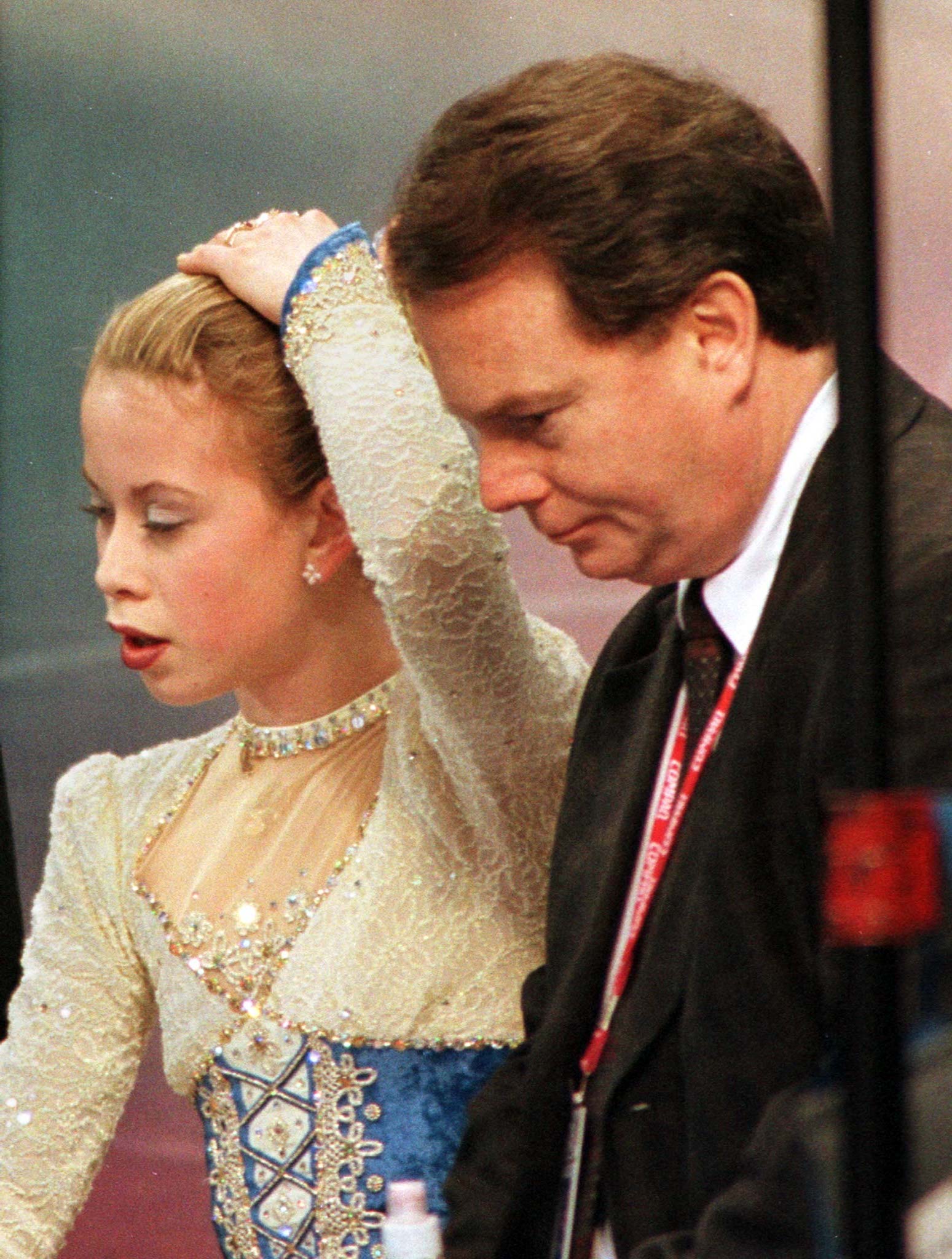 PHOTO: Coach Richard Callahan stands next to defending world and U.S. champion Tara Lipinski as judges reveal their scores following her short program routine at the U.S. National Figure Skating Championships in Philadelphia, Jan. 8, 1998.