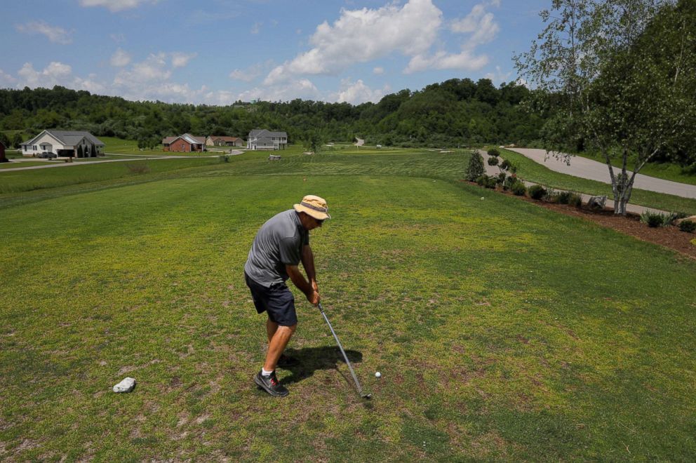 PHOTO: A man plays on a golf course built on the site of a former strip surface coal mine in Jenkins, Ky., May 20, 2018.
