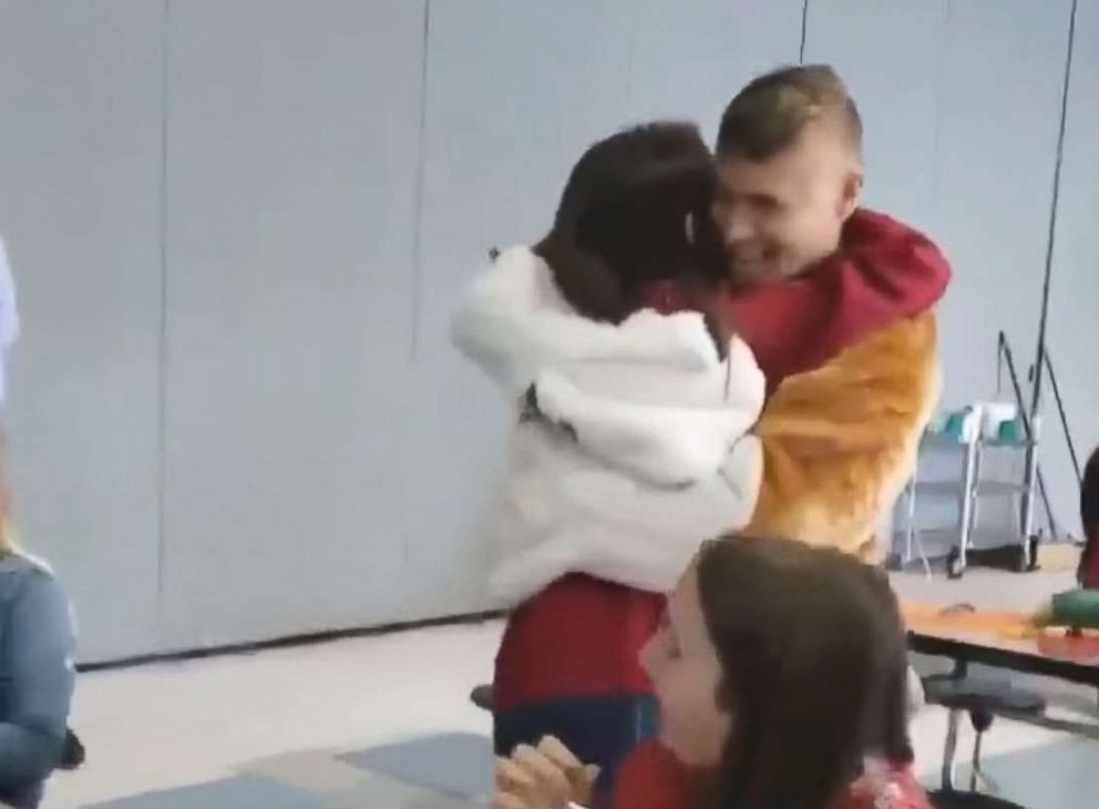 PHOTO: A Coast Guard sergeant surprises his daughter at school dressed as the school mascot.