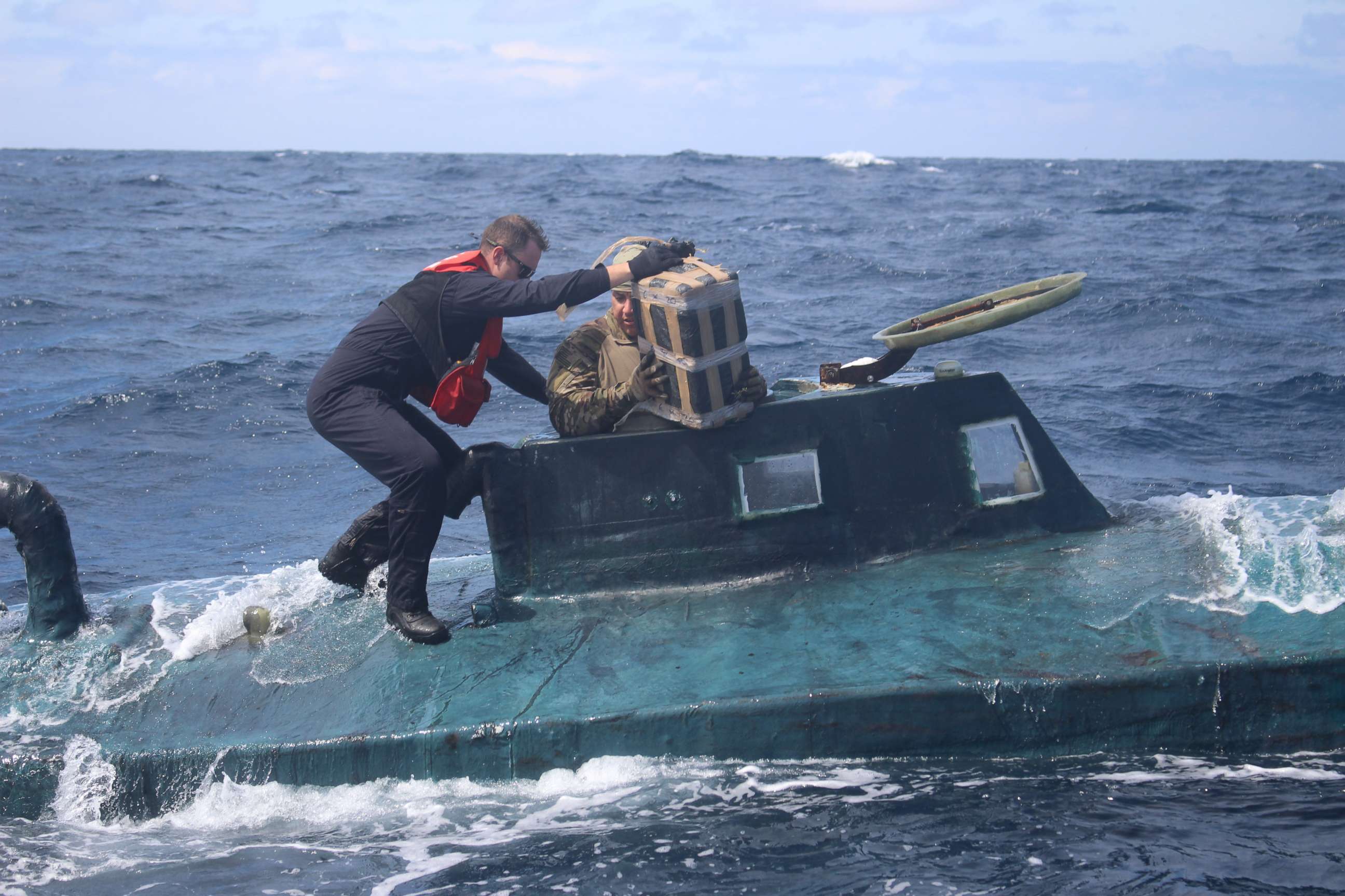 PHOTO: U.S. Coast Guard boarding team members climb aboard a suspected smuggling vessel in the Eastern Pacific in September 2019.