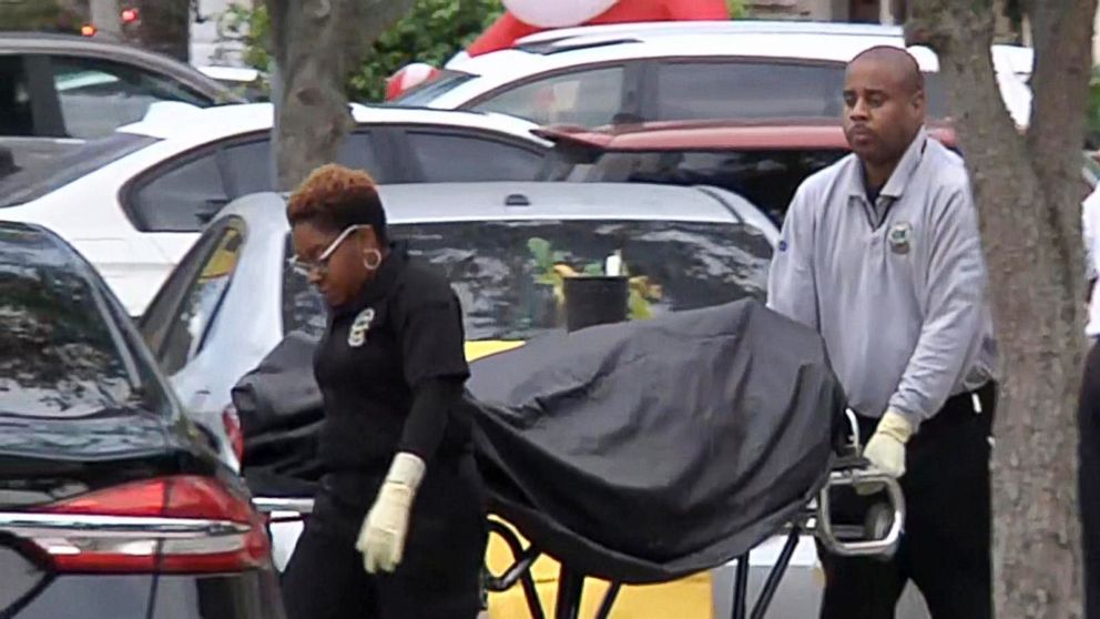 PHOTO: A body is removed from the scene in Miami-Dade County where a Coast Guard serviceman allegedly shot and killed his wife and son before killing himself, Dec. 16, 2018. His 8-year-old daughter was also critically wounded in the shooting.