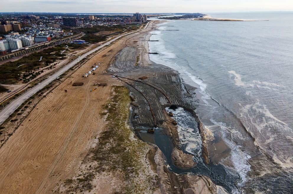 PHOTO: Contractors for the U.S. Army Corps of Engineers pump sand from the ocean floor onto the beach in the Rockaway Peninsula in New York City, Oct. 18, 2022.