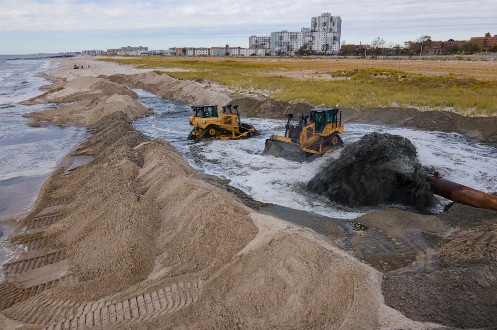 PHOTO: Contractors for the U.S. Army Corps of Engineers pump sand from the ocean floor onto the beach in the Rockaway Peninsula in New York City, Oct. 18, 2022.