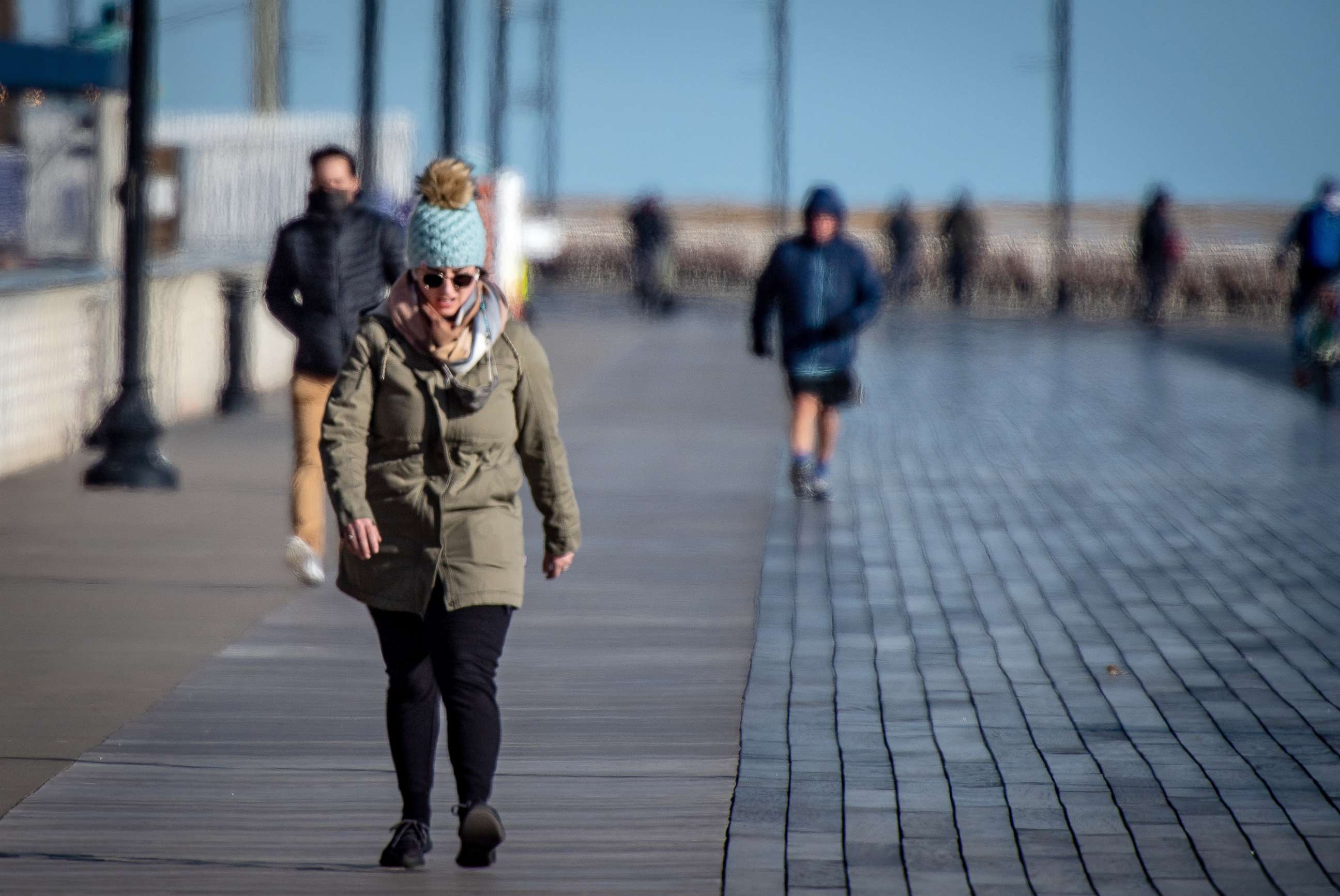 PHOTO: People brave the bitter cold weather to get some exercise by walking on the boardwalk in Long Beach, N.Y.,  Jan. 28, 2021.
