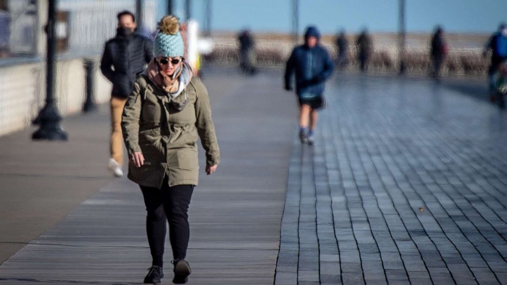 PHOTO: People brave the bitter cold weather to get some exercise by walking on the boardwalk in Long Beach, N.Y.,  Jan. 28, 2021.