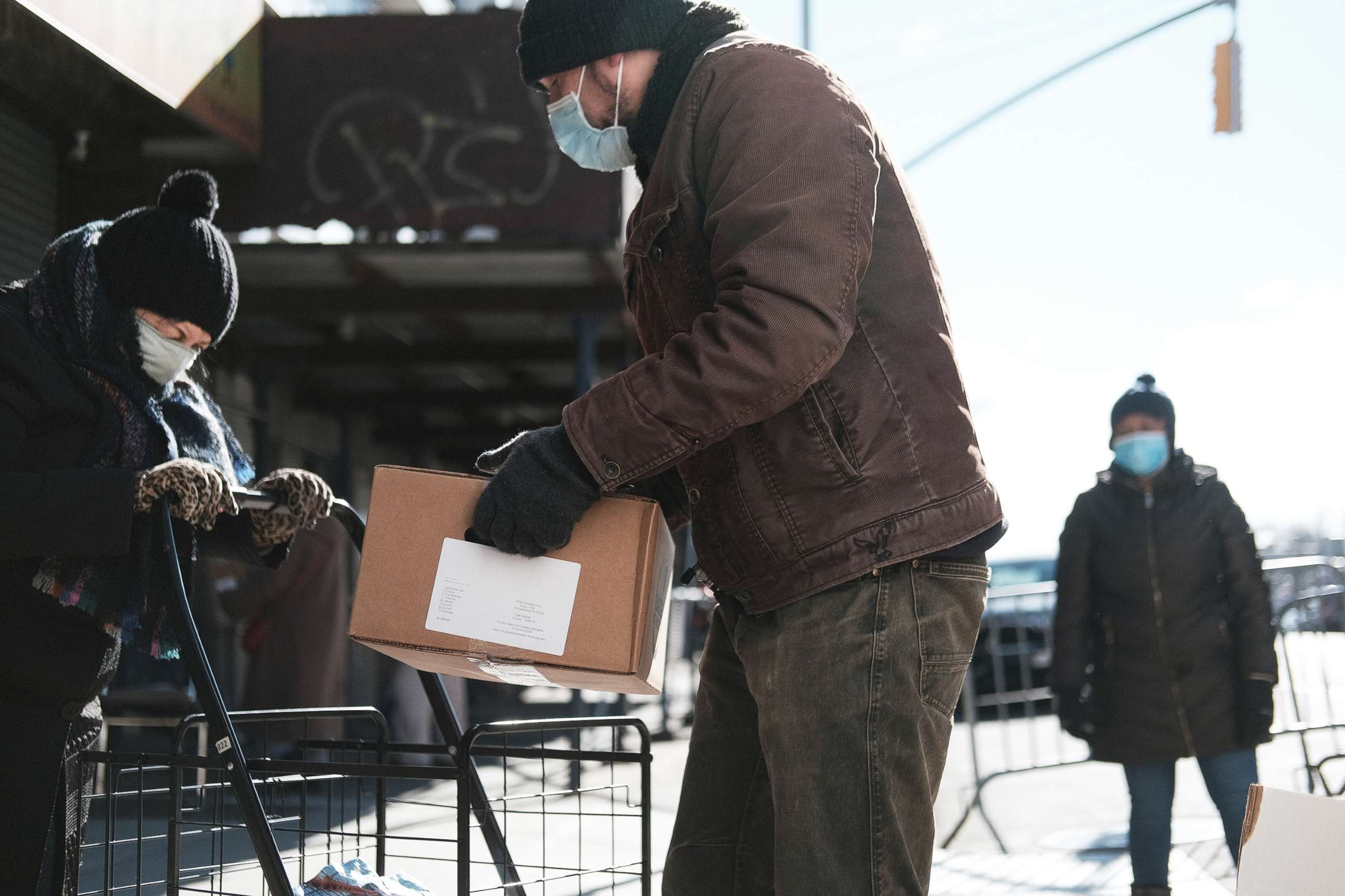 PHOTO: Bundled up people receive food outside of a Brooklyn mosque and cultural center  in New York Jan. 29, 2021.