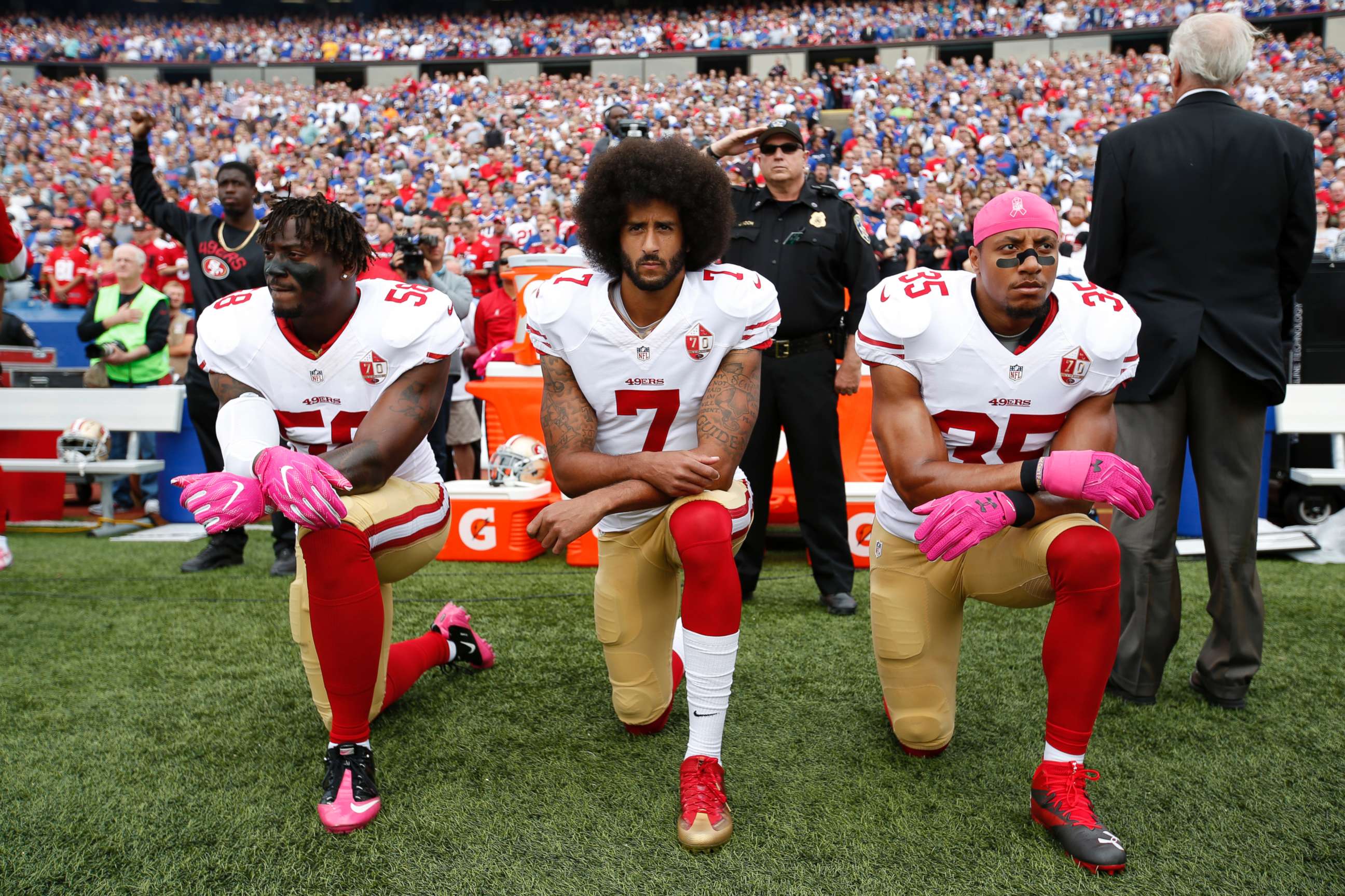 PHOTO: Eli Harold #58, Colin Kaepernick #7, center, and Eric Reid #35 of the San Francisco 49ers kneel in protest on the sideline, during the anthem, prior to the game against the Buffalo Bills at New Era Field, Oct. 16, 2016, in Orchard Park, New York.