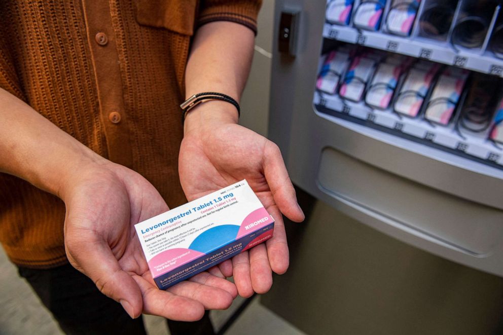 PHOTO: A person holds a carton of the "morning-after" pill purchased from the Plan-B vending machine that sits in the basement of the student union building on the Boston University Campus in Boston, July 26, 2022. 
