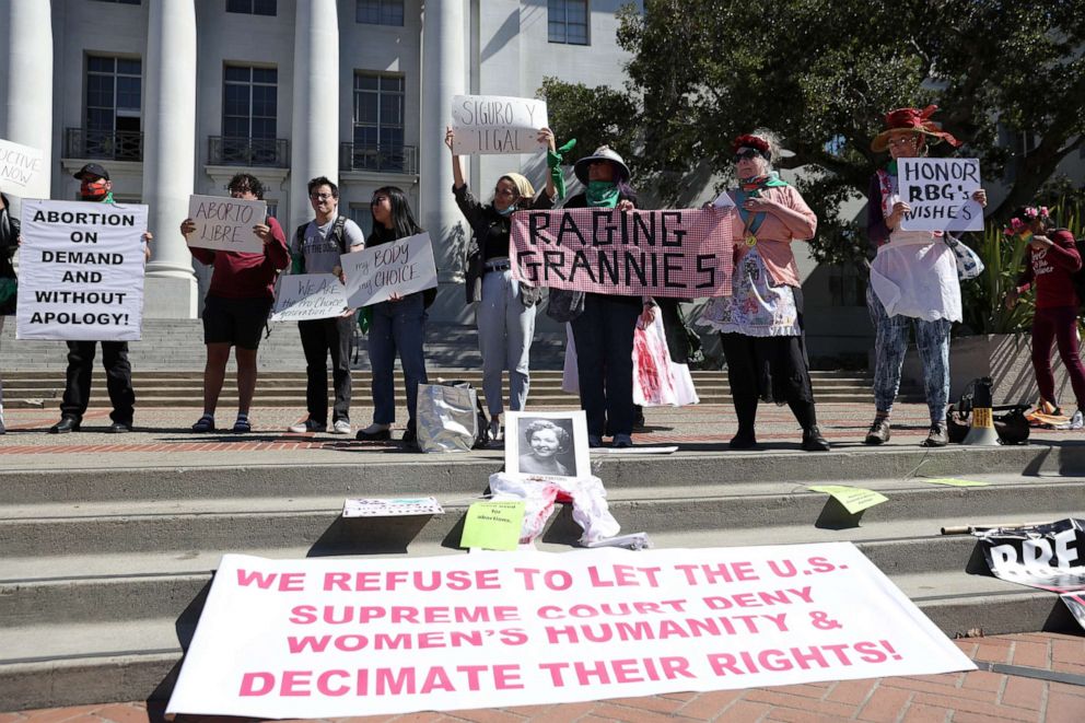 PHOTO: Demonstrators hold signs as they stage a protest in favor of abortion rights on the steps of Sproul Hall on the U.C. Berkeley campus on March 08, 2022 in Berkeley, Calif. 
