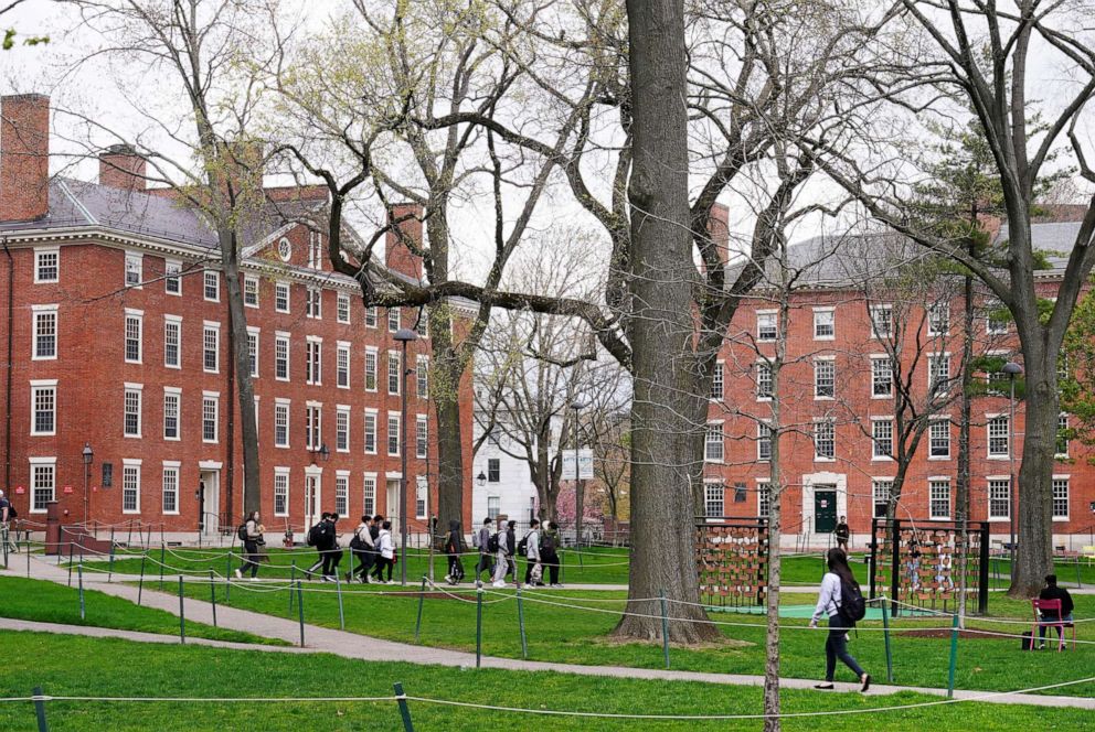 PHOTO: Students walk through Harvard Yard on the campus of Harvard University in Cambridge, Mass., April 27, 2022.