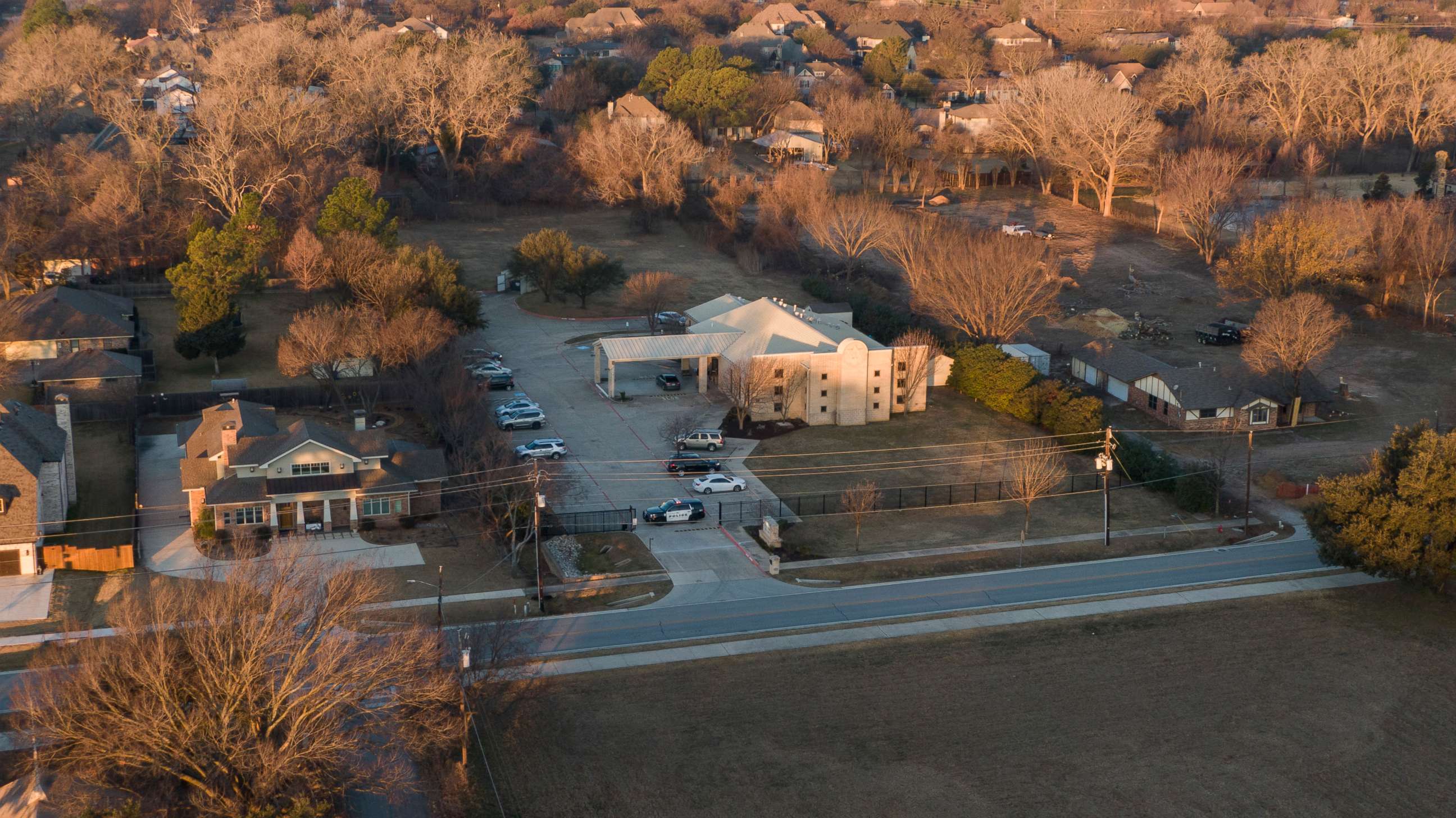 PHOTO: An aerial view of police standing in front of the Congregation Beth Israel synagogue, Jan. 16, 2022, in Colleyville, Texas, where a man held hostages for more than 10 hours inside the temple.
