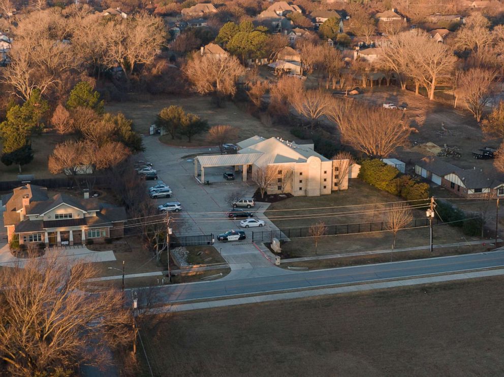PHOTO: An aerial view of police standing in front of the Congregation Beth Israel synagogue, Jan. 16, 2022, in Colleyville, Texas, where a man held hostages for more than 10 hours inside the temple.