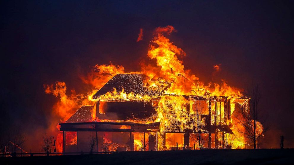 PHOTO: A home burns after a fast moving wildfire swept through the area in the Centennial Heights neighborhood of Louisville, Colo., Dec. 30, 2021.
