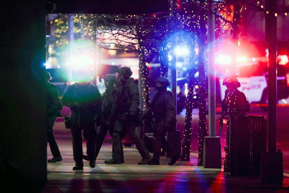 PHOTO: Police SWAT team members walk through the Belmar shopping center on Dec. 27, 2021 in Lakewood, Colo.