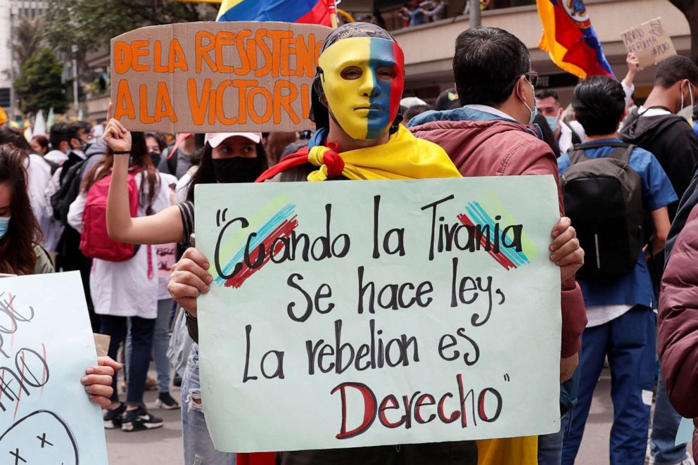 PHOTO: A demonstrators holds a sign that says "When tyranny becomes law, rebellion is a right" during a new day of protests for a 'national strike' called by unions and social organizations in Bogota, Colombia, May 5, 2021. 