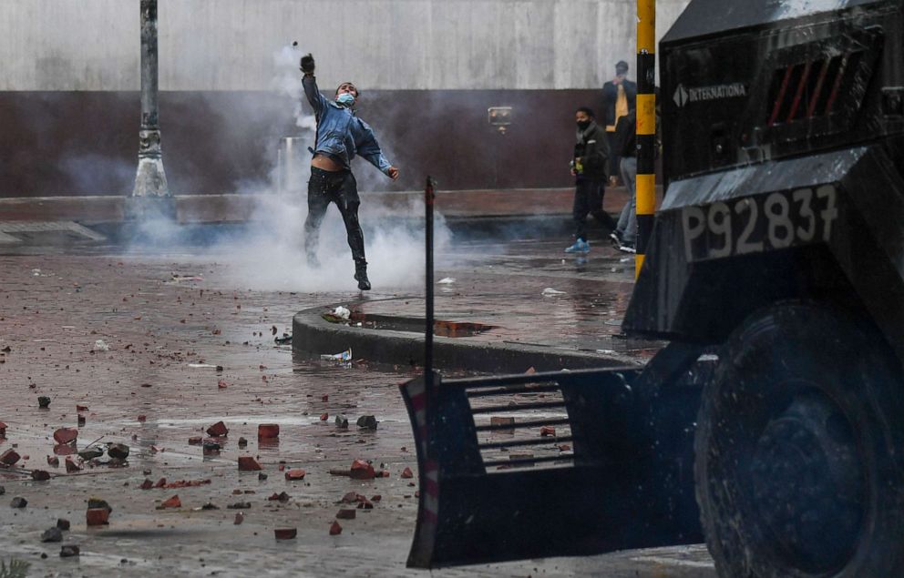 PHOTO: A demonstrator throws a stone at riot police vehicle during a protest against President Ivan Duque's government at the Bolivar square in Bogota, Columbia, May 5, 2021. 