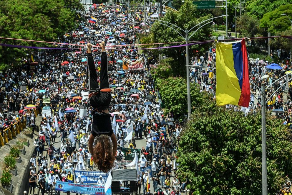 PHOTO: A demonstrator hangs on a slackline during a protest against President Ivan Duque's government in Medellin, Colombia, May 5, 2021.