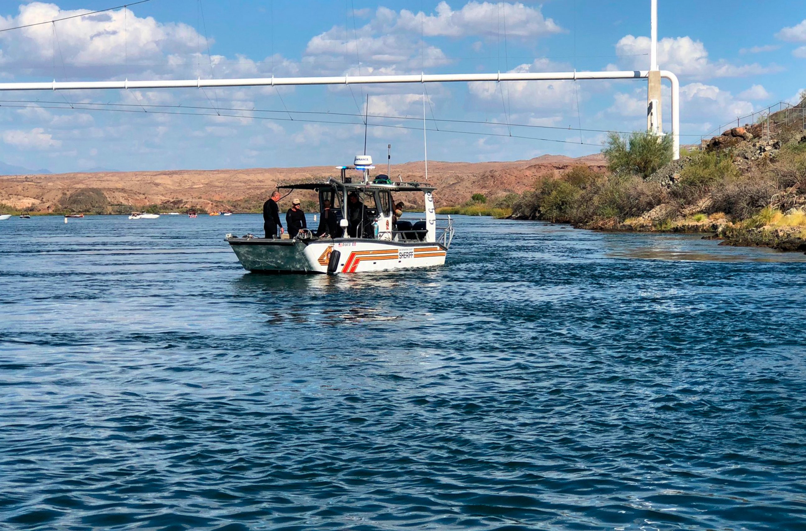 In this photo released by the San Bernardino County, Calif., Sheriff's Office, shows search and recovery operations Monday, Sept. 3, 2018, for three people missing after two boats collided Saturday evening on the Colorado River near Topock, Ariz.