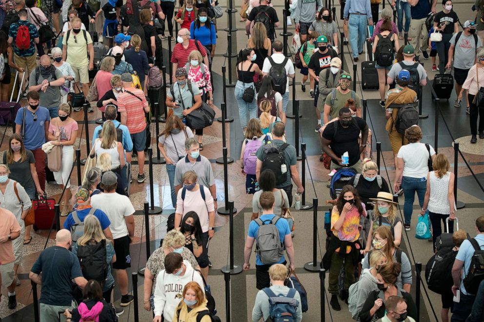 PHOTO: Travelers queue up in long lines to pass through the south security checkpoint in Denver International Airport, on June 16, 2021, in Denver.