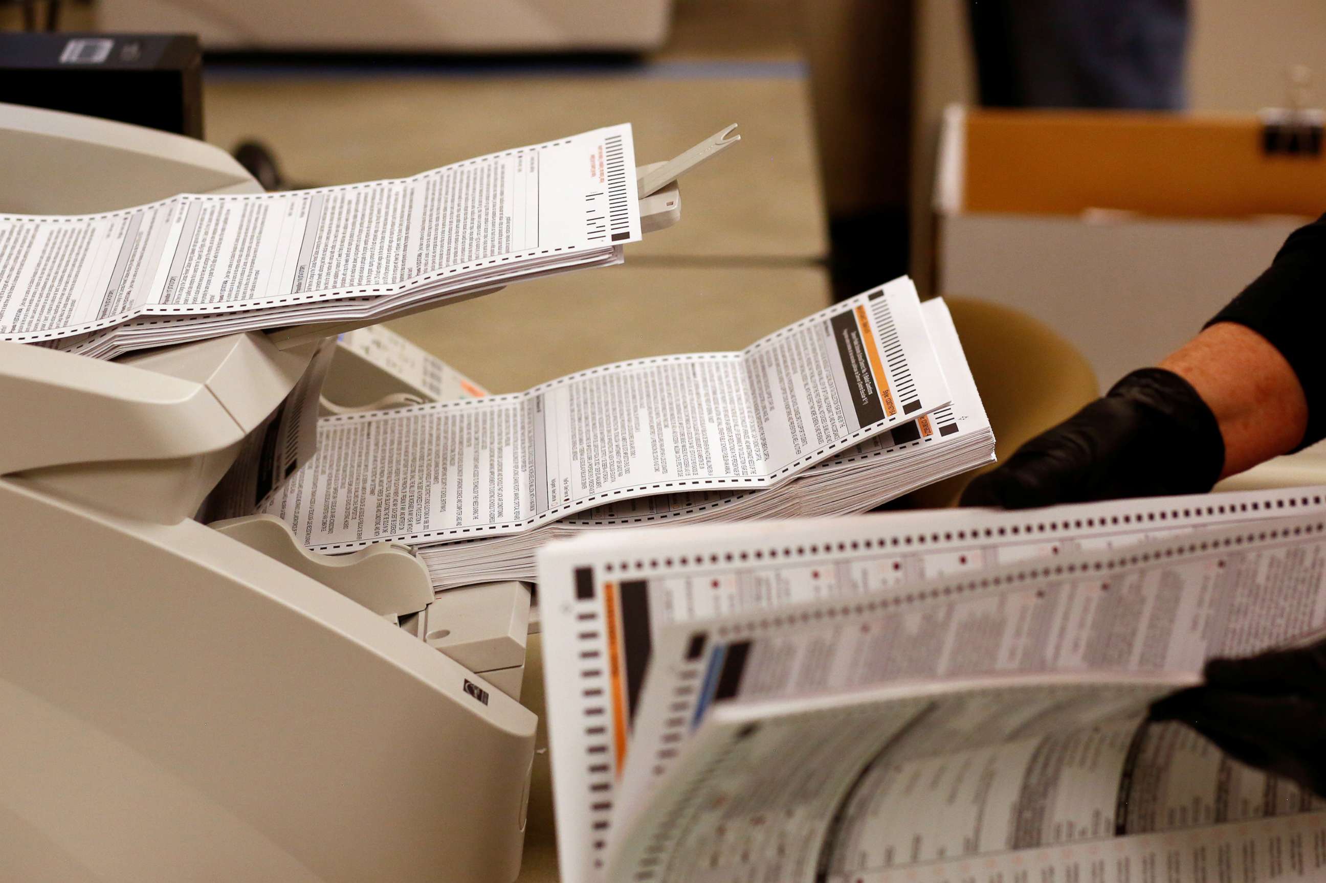 PHOTO: Mail-in ballots are processed and counted for the upcoming presidential election in Denver, Oct. 22, 2020.