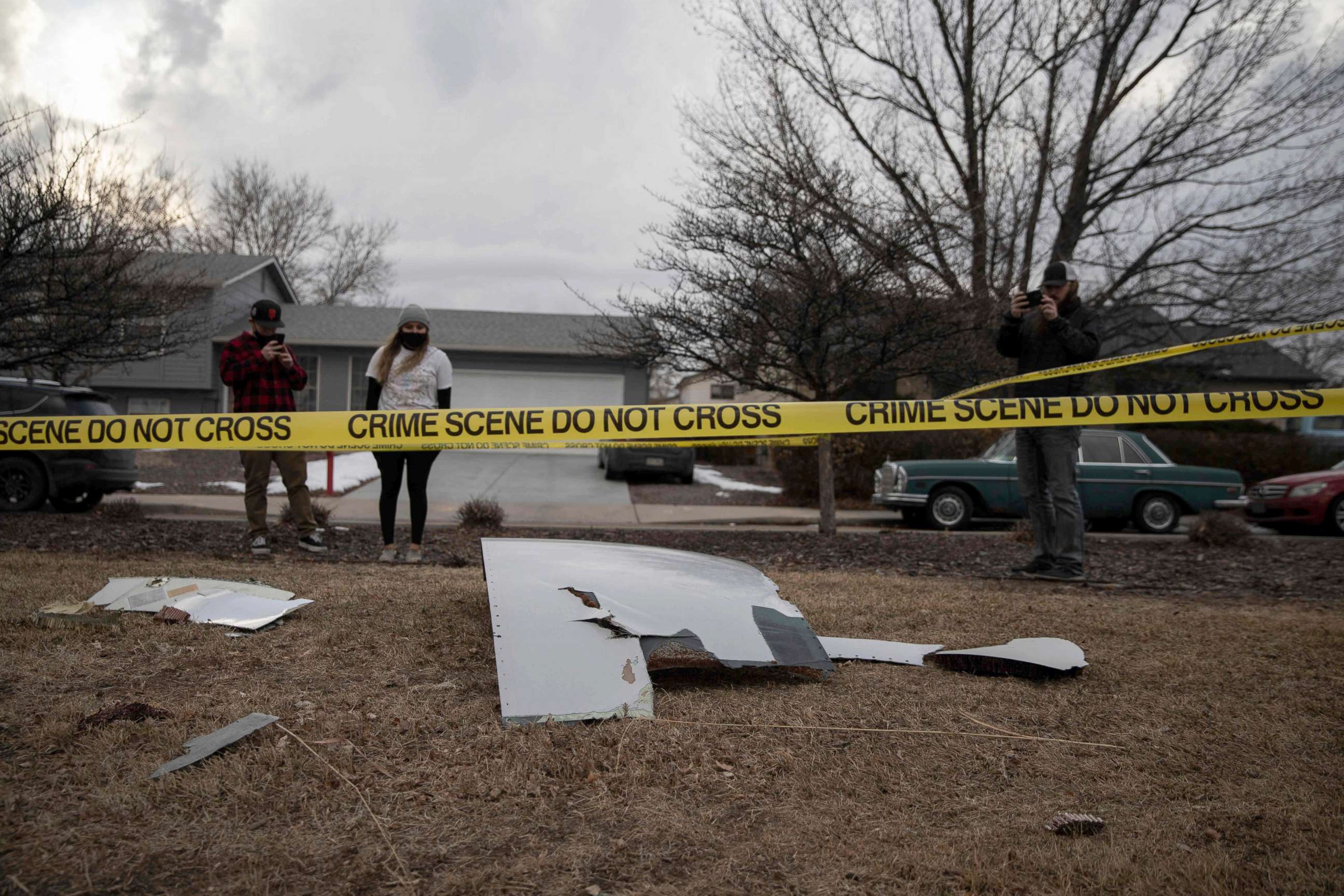 PHOTO: Residents take pictures of debris fallen from a United Airlines airplane's engine on the neighborhood of Broomfield, Colorado, Feb. 20, 2021.