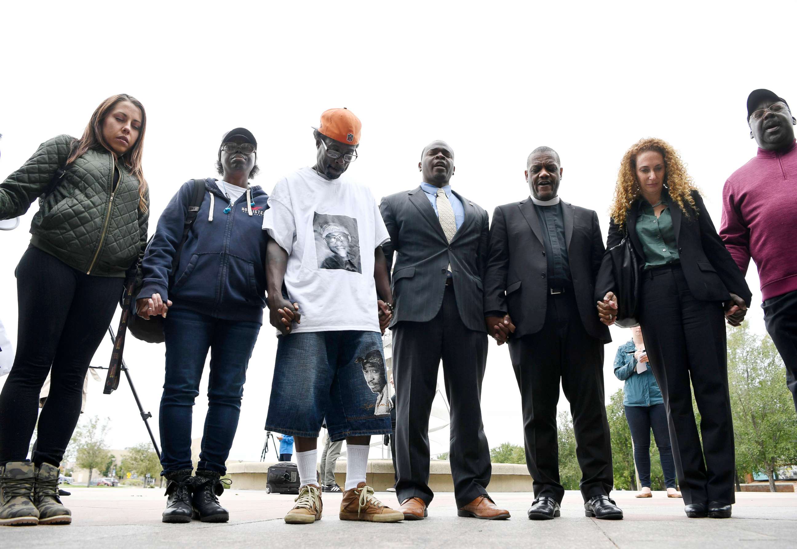 PHOTO: Sheneen McClain and LaWayne Mosley, center, the parents of Elijah McClain, hold hands and pray with supporters after a press conference in front of the Aurora Municipal Center, Aurora, Colo., Oct. 01, 2019.