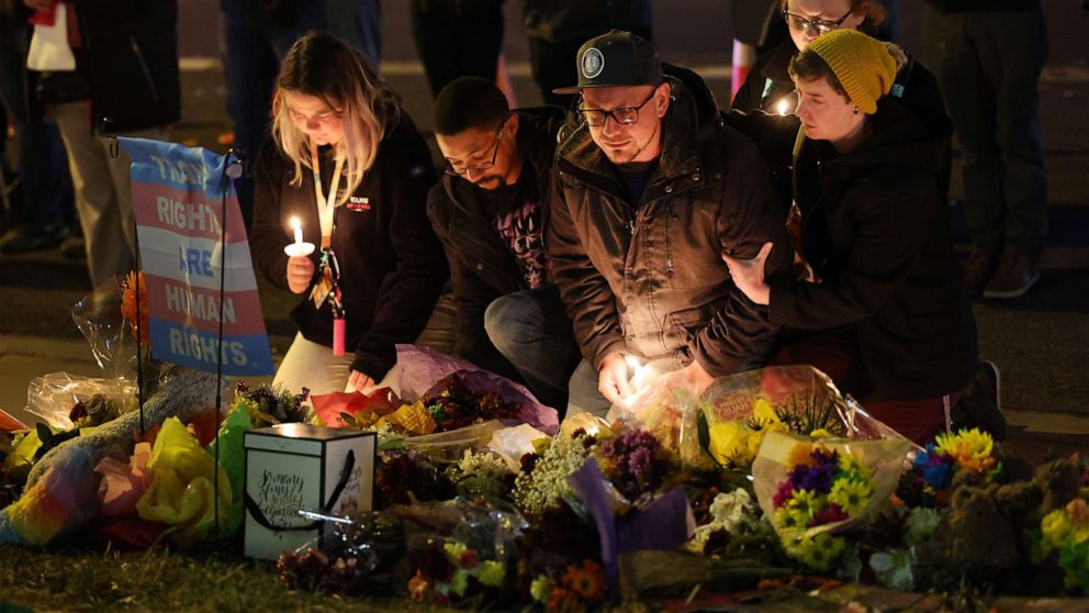 PHOTO: People hold a vigil at a makeshift memorial near the Club Q nightclub, Nov. 20, 2022, in Colorado Springs, Colorado. 