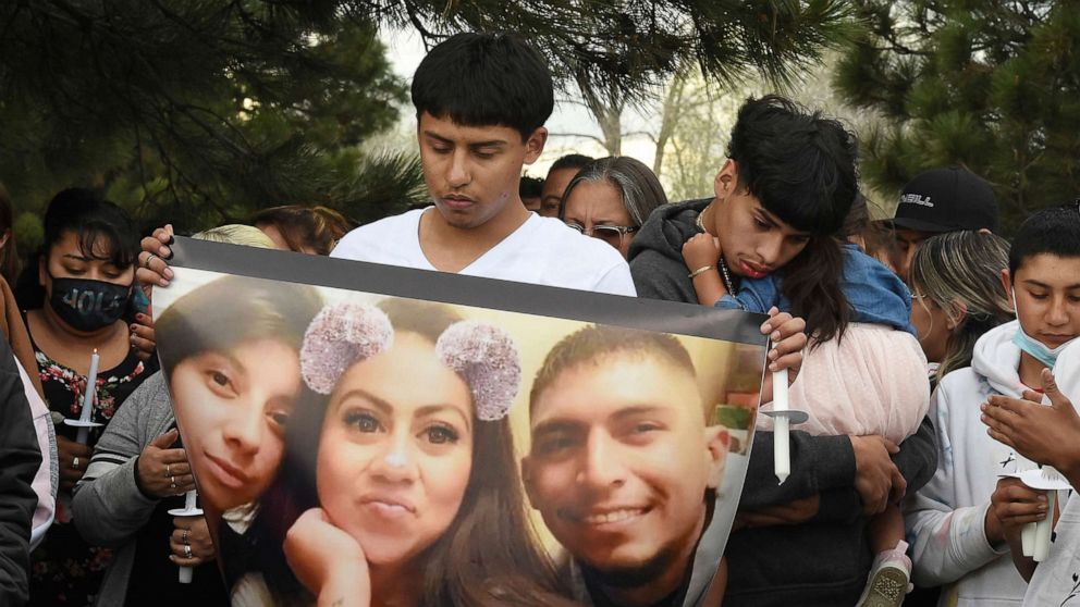 PHOTO: Edgar Ortiz holds a photo showing siblings Sandra Ibarra, 28; Mayra Ibarra de Perez, 33; and Jose Ibarra, 26, from left, at a vigil, May 13, 2021, in Colorado Springs, Colo. for the victims of a May 9 shooting at a birthday party.