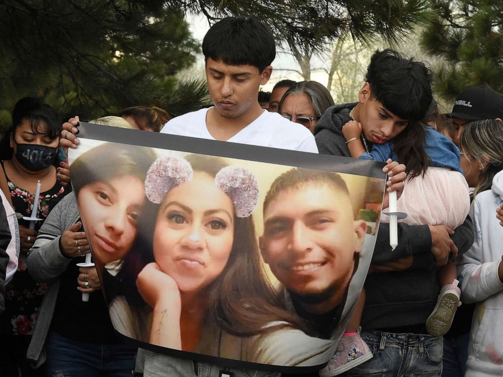 PHOTO: Edgar Ortiz holds a photo showing siblings Sandra Ibarra, 28; Mayra Ibarra de Perez, 33; and Jose Ibarra, 26, from left, at a vigil, May 13, 2021, in Colorado Springs, Colo. for the victims of a May 9 shooting at a birthday party.