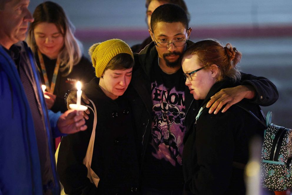 PHOTO: People hold a vigil at a makeshift memorial near Club Q nightclub on November 20, 2022 in Colorado Springs, Colorado.