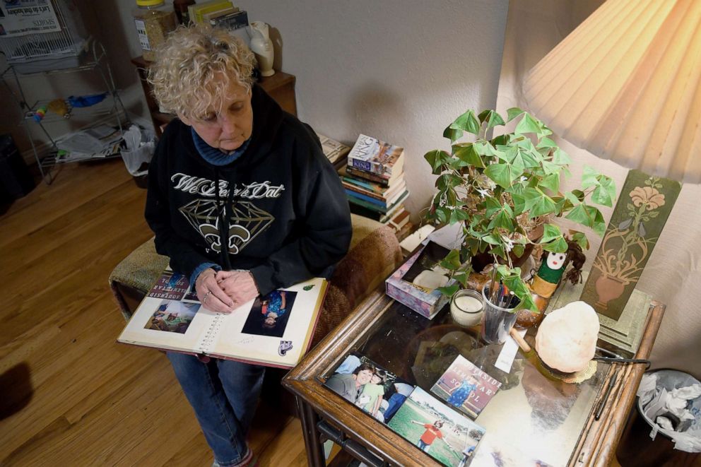 PHOTO: Sabrina Aston looks at childhood photos of her 28-year-old son, Daniel Aston, in her home in Colorado Springs, Colo., on Sunday, Nov. 20, 2022. Daniel was one of five people killed when a gunman opened fire in a gay nightclub in Colorado Springs.