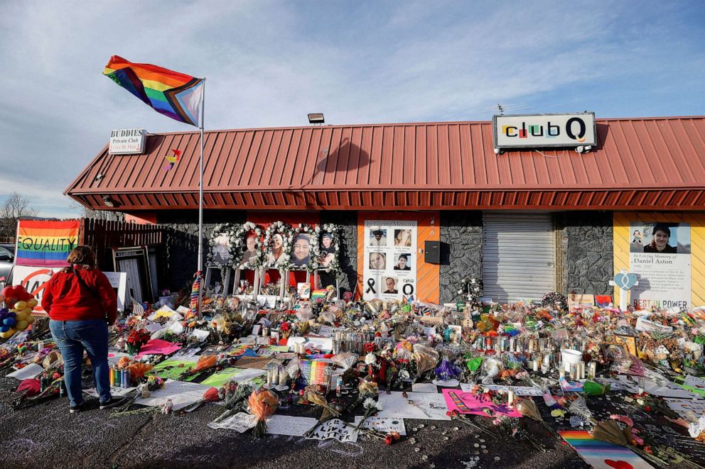 PHOTO: A person looks at the flowers and mementos left at a memorial at Club Q after a mass shooting at the LGBTQ nightclub in Colorado Springs, Colo., Nov. 26, 2022.