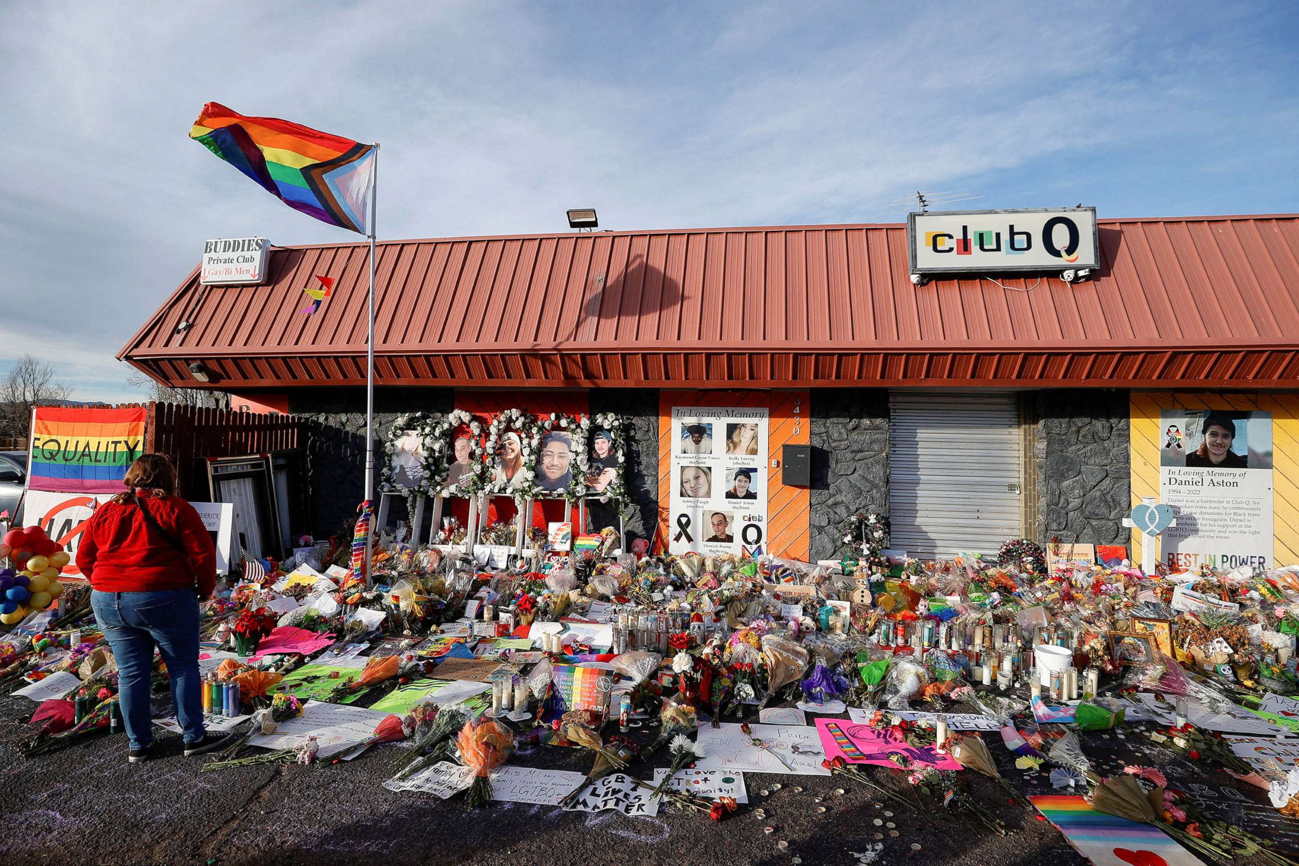 PHOTO: A person looks on at the flowers and mementos left at a memorial at Club Q after a mass shooting at the LGBTQ nightclub in Colorado Springs, Colorado, Nov. 26, 2022.