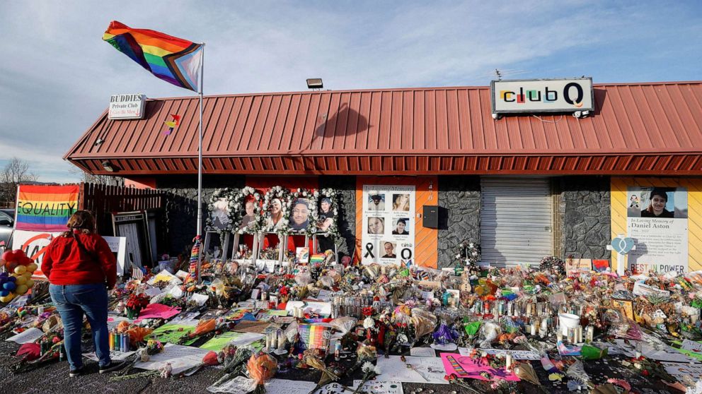 PHOTO: A person looks on at the flowers and mementos left at a memorial at Club Q after a mass shooting at the LGBTQ nightclub in Colorado Springs, Colorado, Nov. 26, 2022.
