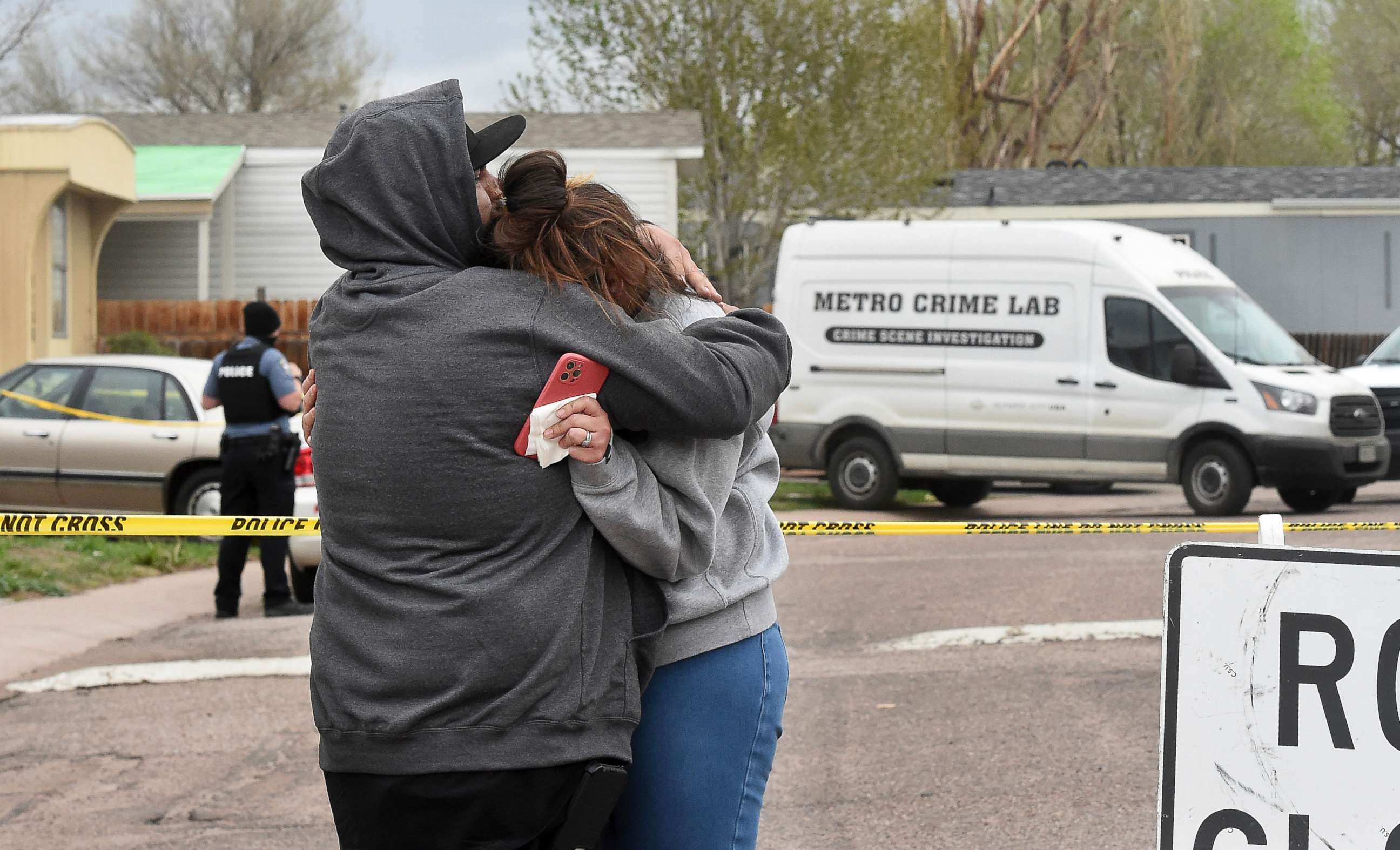 PHOTO: Freddy Marquez kisses the head of his wife, Nubia Marquez, near the scene where her mother and other family members were killed in a mass shooting early Sunday, May 9, 2021, in Colorado Springs, Colo.