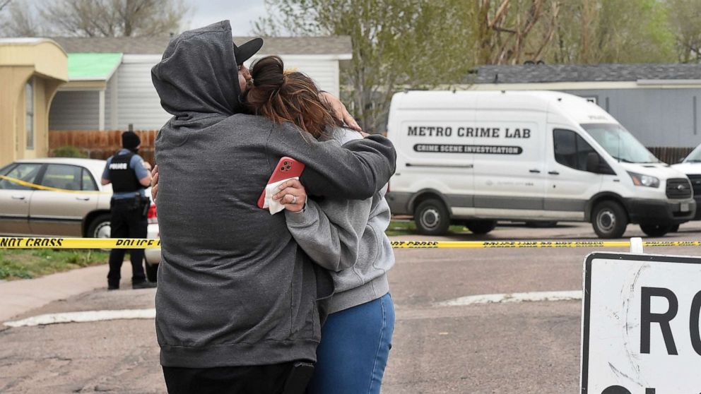 PHOTO: Freddy Marquez kisses the head of his wife, Nubia Marquez, near the scene where her mother and other family members were killed in a mass shooting early Sunday, May 9, 2021, in Colorado Springs, Colo.