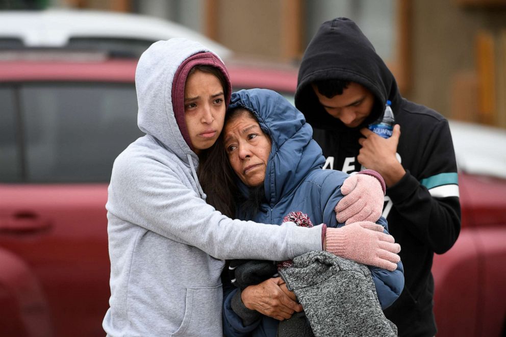 PHOTO: Family members of some of the six shooting victims hug one another outside the scene of the shooting at the Canterbury Mobile Home Park on May 9, 2021, in Colorado Springs, Colo.