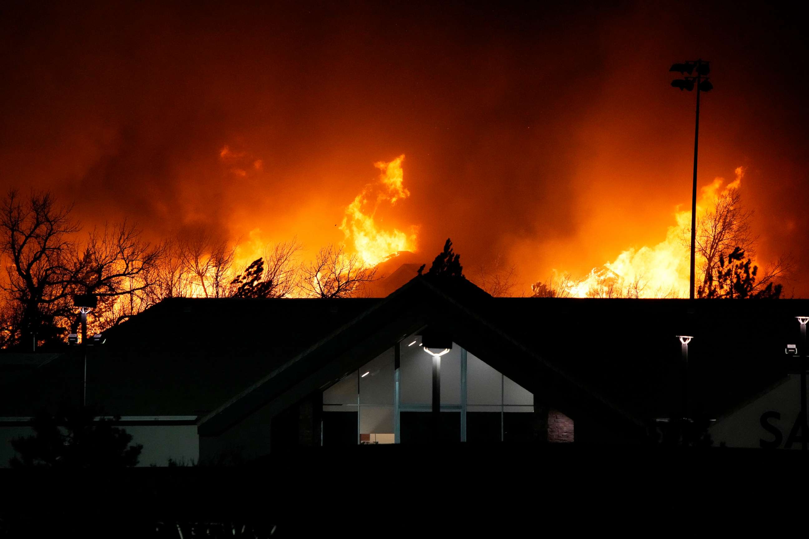 PHOTO: Flames explode as wildfires burned near a small shopping center near Broomfield, Colo., Dec. 30, 2021.