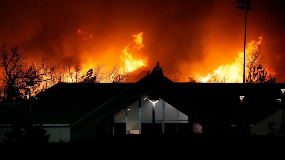 PHOTO: Flames explode as wildfires burned near a small shopping center near Broomfield, Colo., Dec. 30, 2021.