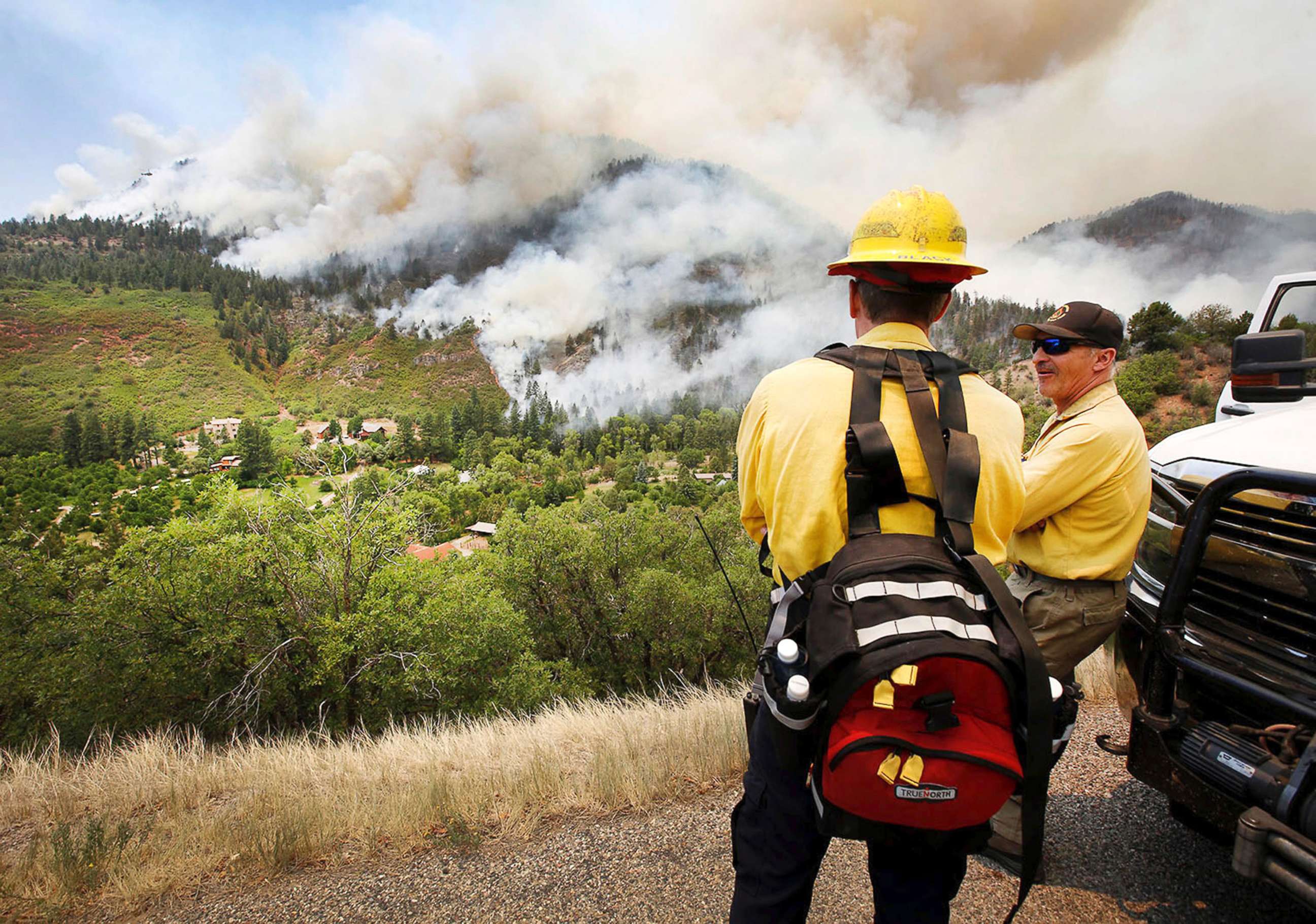 PHOTO: Randy Black, deputy chief of Durango Fire Protection District, and Mike Tombolato, a Rocky Mountain Type One Team member, look over as a fire burns south of County Road 202 during a burnout operation, near Durango, Colo., June 11, 2018.