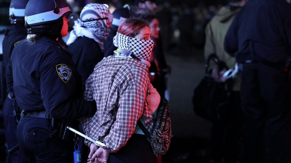 NYPD officers arrest students as they evict a building that had been barricaded by pro-Palestinian student protesters at Columbia University, in New York City on April 30, 2024. (Photo by CHARLY TRIBALLEAU/AFP via Getty Images)