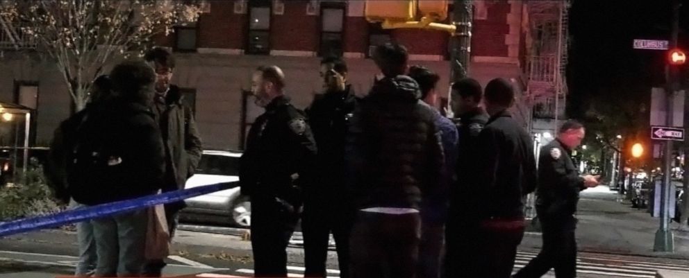 PHOTO: Students and police gather at the scene were a Columbia University student was killed and a tourist was wounded in Upper Manhattan, N.Y., Dec. 2, 2021.
