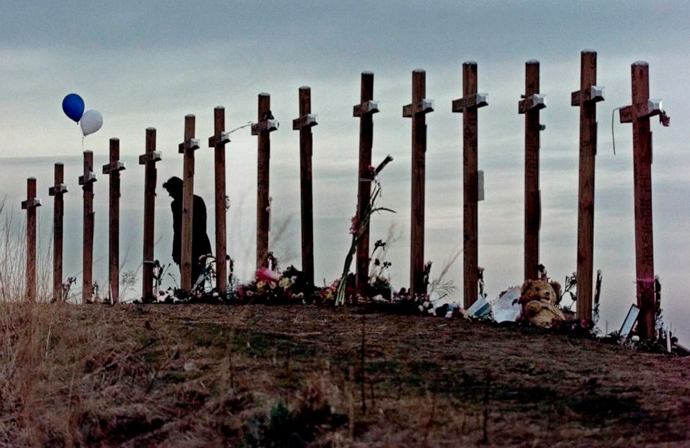 PHOTO: On April 28, 1999, a woman looks at crosses posted on a hill above Columbine High School in Littleton, Colo., in remembrance of the people who died during a shooting rampage at the school.