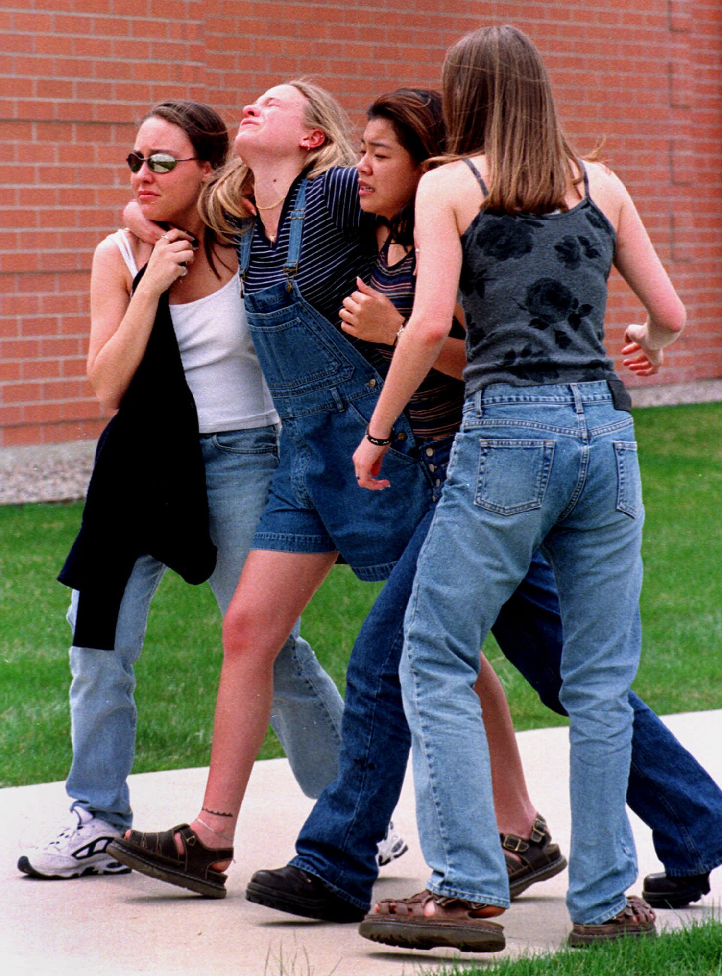 PHOTO: Young women head to a location near Columbine High School where students and faculty members were evacuated after two gunmen went on a shooting rampage in the school in the southwest Denver suburb of Littleton, Colo., April 20, 1999.