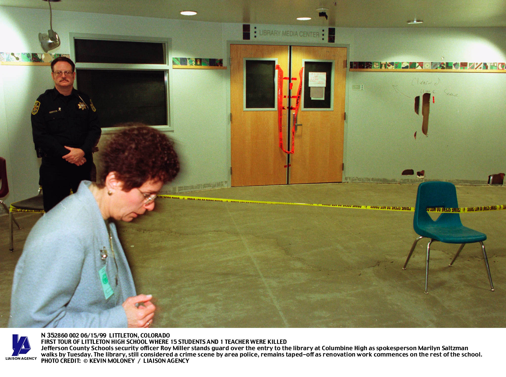 PHOTO: A security officer stands guard at the entrance to the Columbine High School library on June 15, 1999, nearly two months after the shooting.