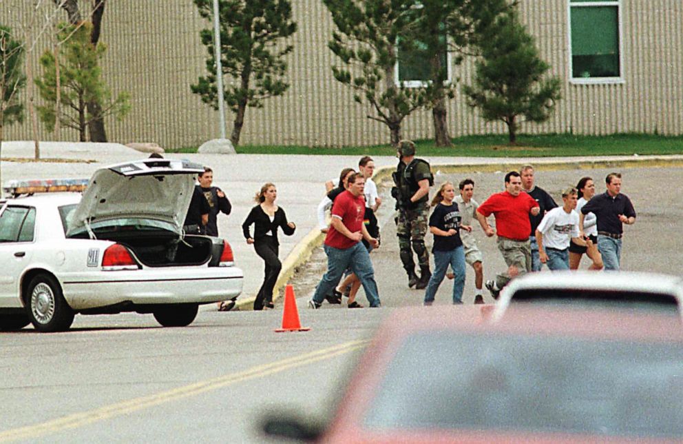 PHOTO: Students run from Columbine High School seeking cover, April 20, 1999 in Littleton, Colorado, after two masked teens stormed the school, killing fellow students before turning the weapons on themselves.